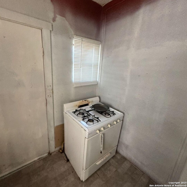 135 Roberts, San Antonio, TX 78207 - kitchen with gas range gas stove and tile patterned floors