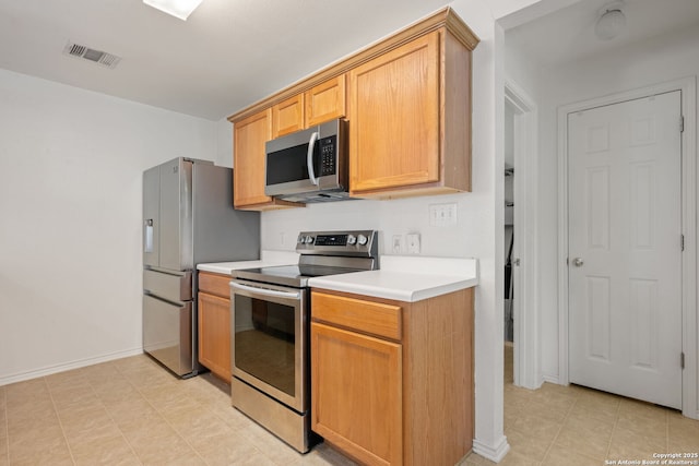 6410 Ruffled Grouse, San Antonio, TX 78233 - kitchen with appliances with stainless steel finishes, light countertops, and light tile patterned floors