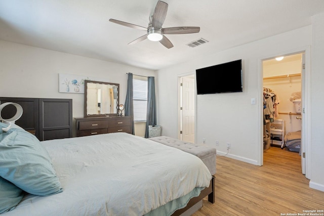 6410 Ruffled Grouse, San Antonio, TX 78233 - bedroom featuring light wood-style floors, a walk in closet, and a ceiling fan