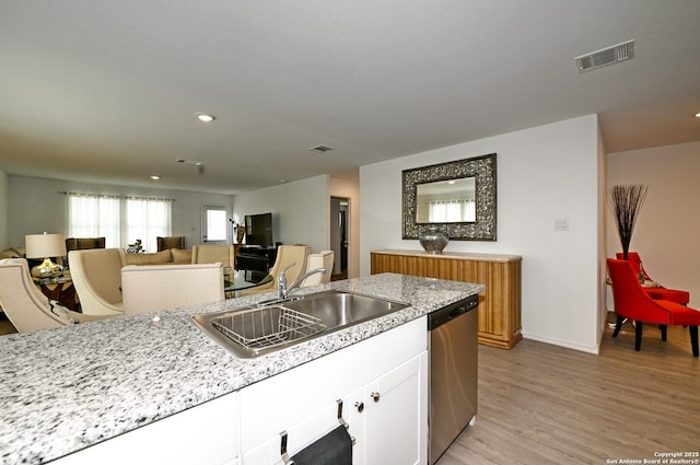 10746 Margarita Loop, Converse, TX 78109 - kitchen with dishwasher, white cabinets, light wood-type flooring, recessed lighting, and light stone countertops