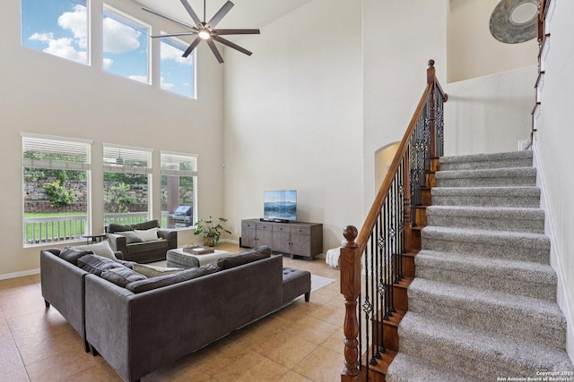 3403 Navajo Peace, San Antonio, TX 78261 - living area featuring a towering ceiling, a ceiling fan, healthy amount of natural light, light tile patterned floors, and stairs