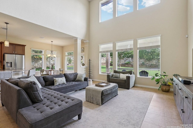 3403 Navajo Peace, San Antonio, TX 78261 - living area with a chandelier, a towering ceiling, light tile patterned flooring, and decorative columns