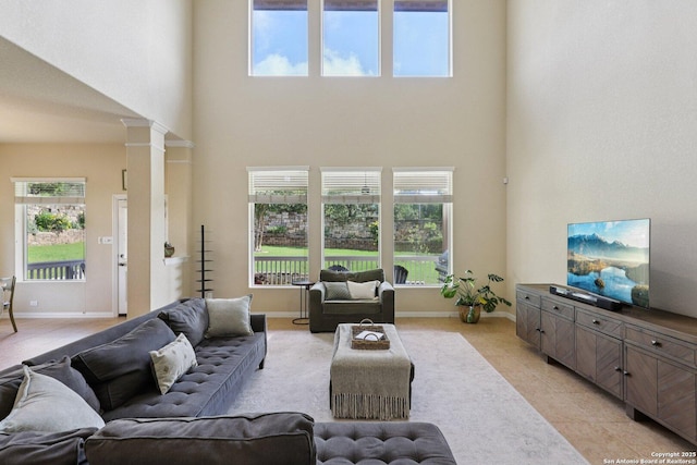 3403 Navajo Peace, San Antonio, TX 78261 - living room with a high ceiling, decorative columns, and light tile patterned floors