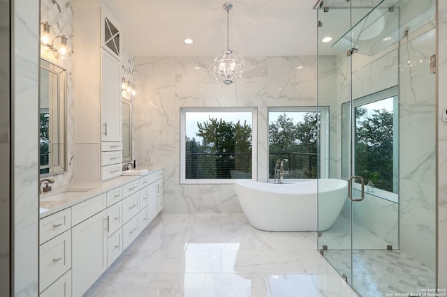 19727 La Sierra Blvd, San Antonio, TX 78256 - bathroom with a freestanding bath, double vanity, a chandelier, marble tiled flooring, and a marble finish shower