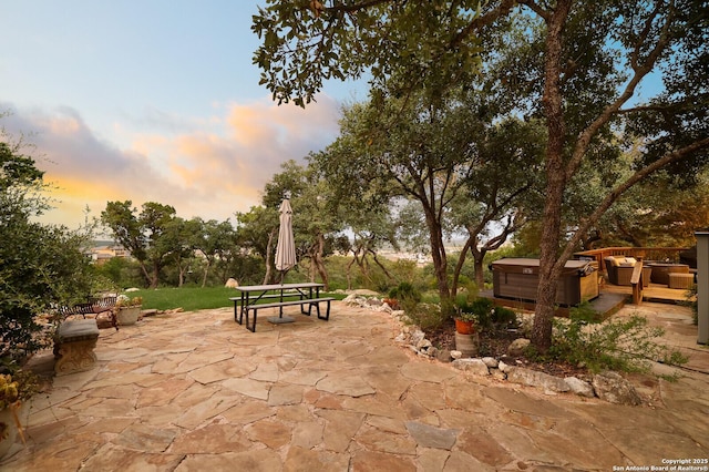 19727 La Sierra Blvd, San Antonio, TX 78256 - patio terrace at dusk featuring a hot tub, a patio, an outdoor hangout area, and outdoor dining space