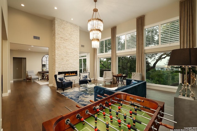 19727 La Sierra Blvd, San Antonio, TX 78256 - playroom with a towering ceiling, hardwood / wood-style floors, a stone fireplace, a chandelier, and recessed lighting