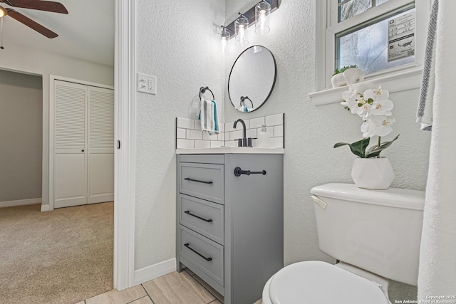 112 Meadow Way, Converse, TX 78109 - bathroom featuring vanity, ceiling fan, and a textured wall