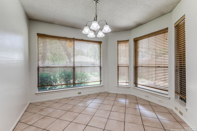 8658 Quail Whisper, San Antonio, TX 78250 - unfurnished dining area with a chandelier, a textured ceiling, and light tile patterned floors