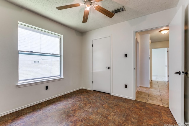 8658 Quail Whisper, San Antonio, TX 78250 - spare room with a textured ceiling and ceiling fan