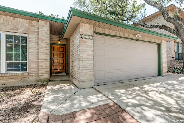 8658 Quail Whisper, San Antonio, TX 78250 - doorway to property featuring brick siding, a garage, and driveway