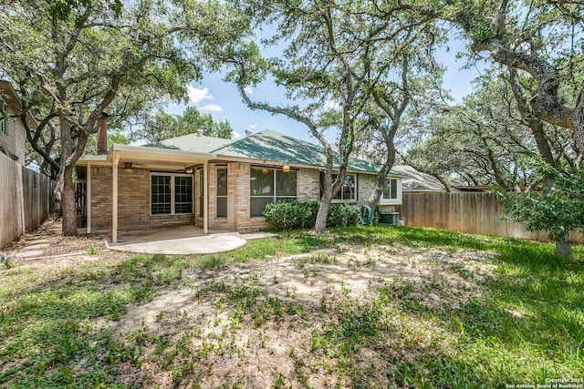 8658 Quail Whisper, San Antonio, TX 78250 - back of house with brick siding, a fenced backyard, and a patio area