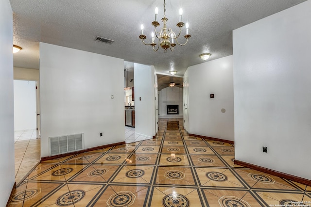 8658 Quail Whisper, San Antonio, TX 78250 - empty room featuring light tile patterned floors, a textured ceiling, a chandelier, and ceiling fan