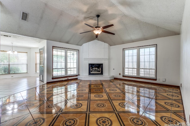 8658 Quail Whisper, San Antonio, TX 78250 - unfurnished living room featuring tile patterned flooring, a ceiling fan, lofted ceiling, a brick fireplace, and a chandelier