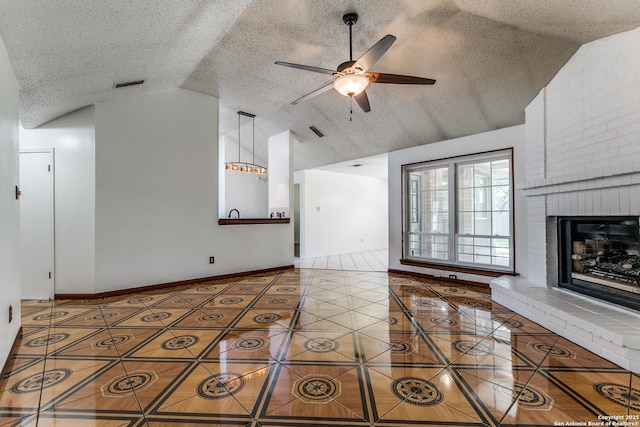 8658 Quail Whisper, San Antonio, TX 78250 - unfurnished living room with tile patterned flooring, ceiling fan, a fireplace, high vaulted ceiling, and a textured ceiling