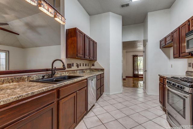 8658 Quail Whisper, San Antonio, TX 78250 - kitchen with appliances with stainless steel finishes, ceiling fan, light tile patterned flooring, and vaulted ceiling