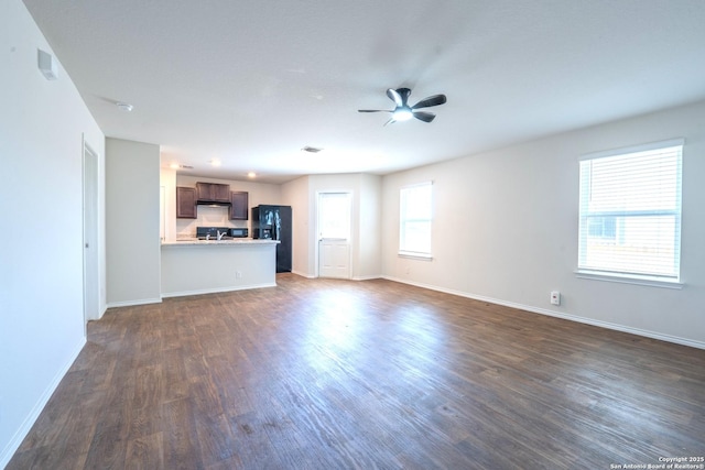 5722 Tanquil Cv, Converse, TX 78109 - unfurnished living room with dark wood-style flooring and ceiling fan