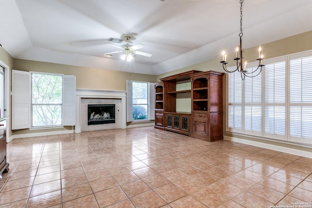 2430 Trace Oak, San Antonio, TX 78232 - unfurnished living room featuring light tile patterned floors, a chandelier, a raised ceiling, and healthy amount of natural light