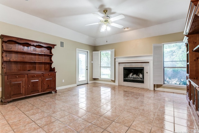 2430 Trace Oak, San Antonio, TX 78232 - unfurnished living room featuring light tile patterned floors, ceiling fan, and a premium fireplace