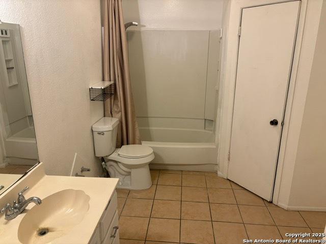 9931 Birch Fld, San Antonio, TX 78245 - full bath featuring tile patterned flooring, vanity, and shower / bathtub combination with curtain