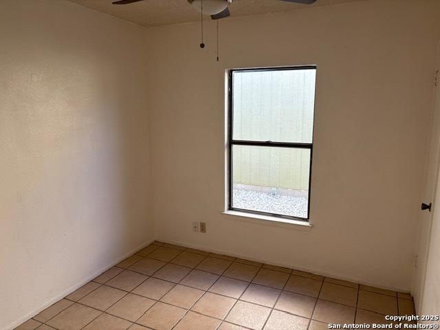 9931 Birch Fld, San Antonio, TX 78245 - empty room with a ceiling fan, healthy amount of natural light, and light tile patterned floors