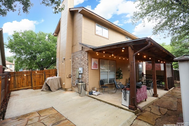 13111 Burgundy Pt, San Antonio, TX 78217 - back of house with a patio area, a chimney, and a fenced backyard