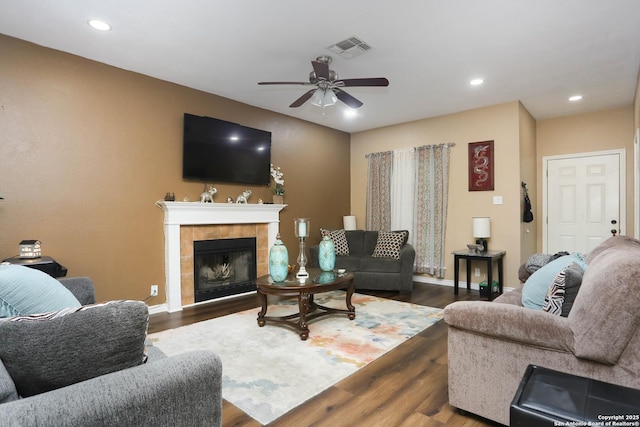 13111 Burgundy Pt, San Antonio, TX 78217 - living area with a ceiling fan, a tiled fireplace, dark wood-style floors, and recessed lighting
