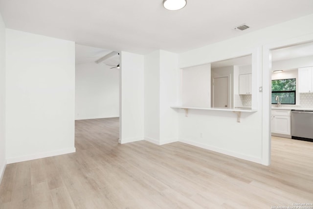 9238 Ridge Wilde, San Antonio, TX 78250 - unfurnished living room with light wood-type flooring and a ceiling fan