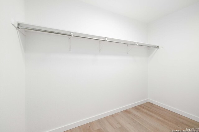 9238 Ridge Wilde, San Antonio, TX 78250 - walk in closet with light wood-type flooring