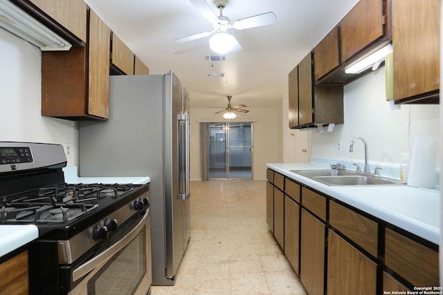 118 Meadow Park, San Antonio, TX 78227 - kitchen featuring stainless steel gas range oven, light flooring, a ceiling fan, and light countertops