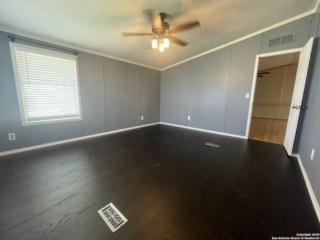 207 S Edwards, Charlotte, TX 78011 - unfurnished room with ceiling fan, a decorative wall, dark wood-type flooring, vaulted ceiling, and crown molding