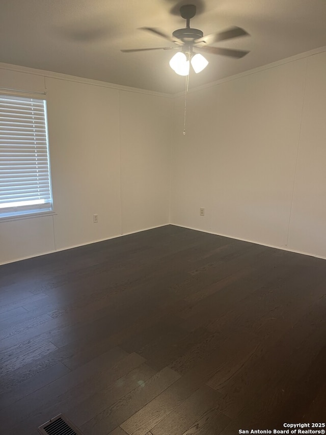 207 S Edwards, Charlotte, TX 78011 - unfurnished room featuring dark wood finished floors, a ceiling fan, and ornamental molding