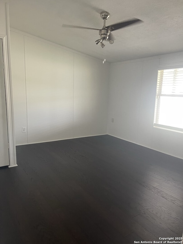 207 S Edwards, Charlotte, TX 78011 - empty room with a ceiling fan and dark wood-style flooring