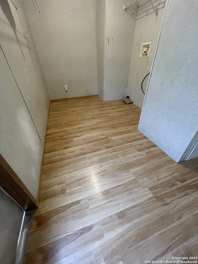 207 S Edwards, Charlotte, TX 78011 - laundry room featuring wood finished floors and washer hookup