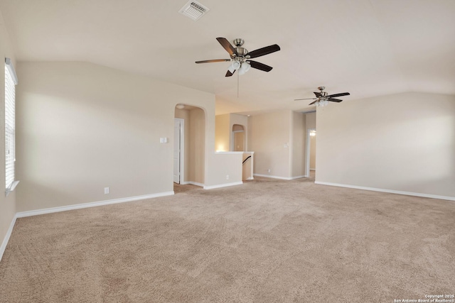 15442 Cooks Petrel, San Antonio, TX 78253 - empty room featuring vaulted ceiling, arched walkways, ceiling fan, and light carpet