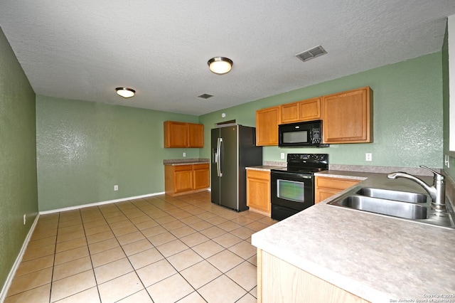 245 Gatewood, Cibolo, TX 78108 - kitchen featuring black appliances, a textured wall, a textured ceiling, light tile patterned floors, and light countertops