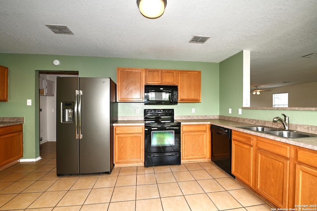 245 Gatewood, Cibolo, TX 78108 - kitchen with black appliances, light tile patterned flooring, ceiling fan, a textured ceiling, and light countertops