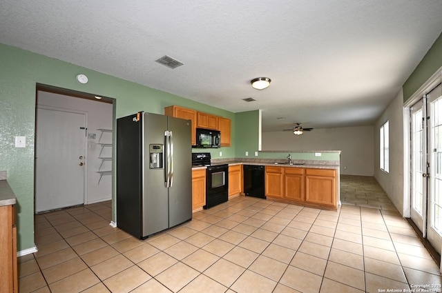 245 Gatewood, Cibolo, TX 78108 - kitchen with black appliances, light countertops, a peninsula, a ceiling fan, and light tile patterned floors