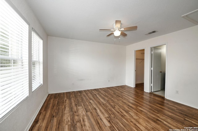 245 Gatewood, Cibolo, TX 78108 - unfurnished bedroom featuring wood finished floors, a walk in closet, and a ceiling fan