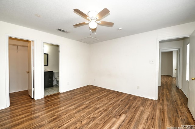 245 Gatewood, Cibolo, TX 78108 - unfurnished bedroom with wood finished floors, a walk in closet, a closet, a ceiling fan, and connected bathroom