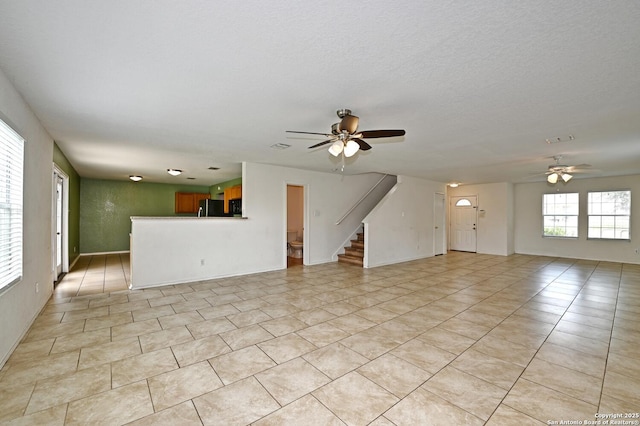 245 Gatewood, Cibolo, TX 78108 - unfurnished living room featuring ceiling fan, light tile patterned flooring, and stairs