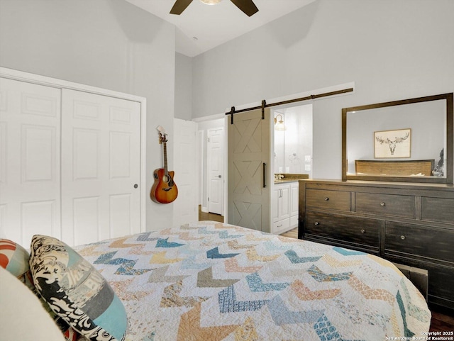 7 Greens Whisper, San Antonio, TX 78216 - bedroom with a barn door, vaulted ceiling, a closet, a ceiling fan, and connected bathroom