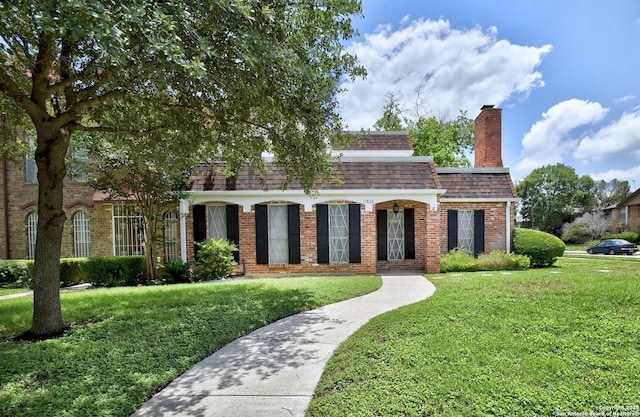 11826 Petal Unit 73, San Antonio, TX 78216 - view of front of home with brick siding, a front yard, roof with shingles, and a chimney