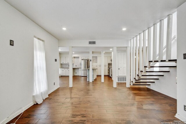 11826 Petal Unit 73, San Antonio, TX 78216 - unfurnished living room with wood finished floors, stairway, and recessed lighting