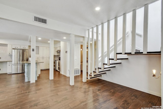 11826 Petal Unit 73, San Antonio, TX 78216 - basement featuring freestanding refrigerator, dark wood finished floors, recessed lighting, and stairway