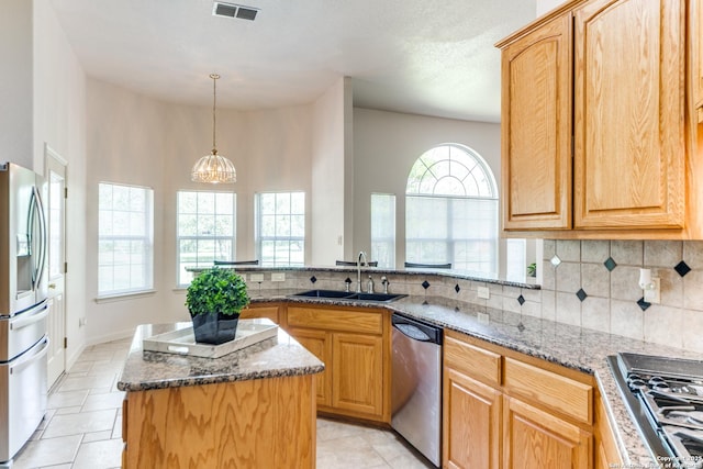 15311 Tamaron Pass, San Antonio, TX 78253 - kitchen with appliances with stainless steel finishes, dark stone counters, tasteful backsplash, and a peninsula