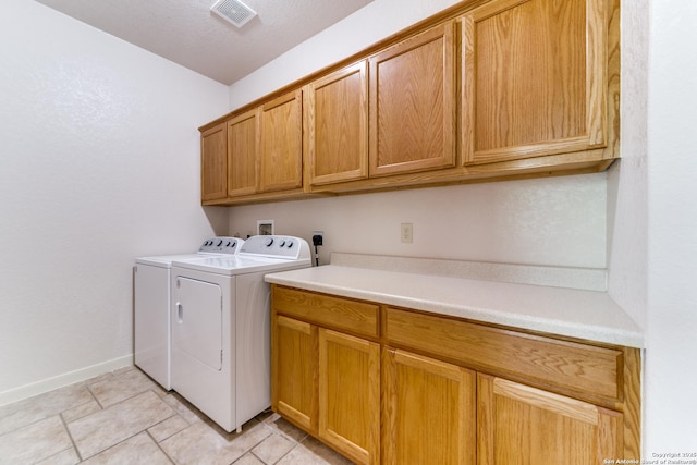 15311 Tamaron Pass, San Antonio, TX 78253 - laundry room with cabinet space, washer and clothes dryer, and light tile patterned flooring