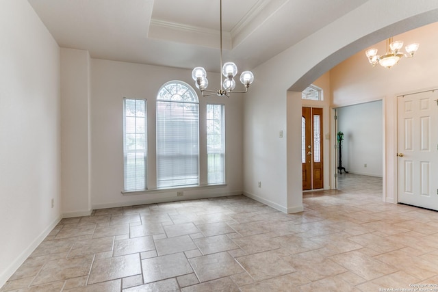 15311 Tamaron Pass, San Antonio, TX 78253 - spare room featuring a chandelier, stone tile floors, arched walkways, crown molding, and a tray ceiling