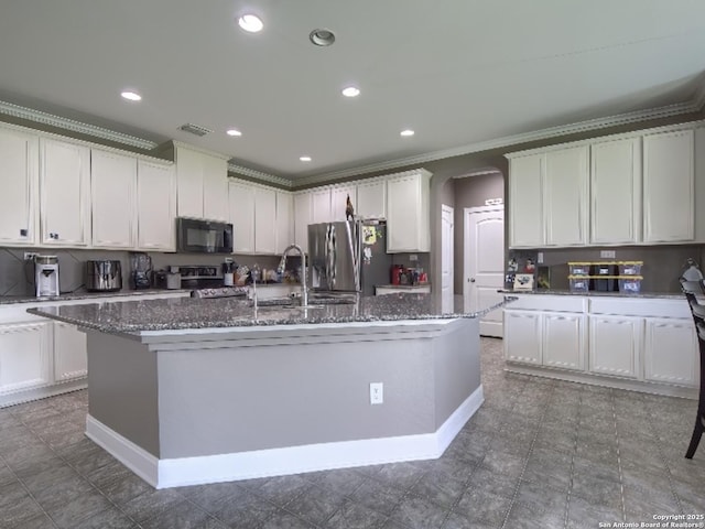 7566 Copper Cv, Converse, TX 78109 - kitchen with stainless steel refrigerator with ice dispenser, black microwave, an island with sink, arched walkways, and dark stone counters