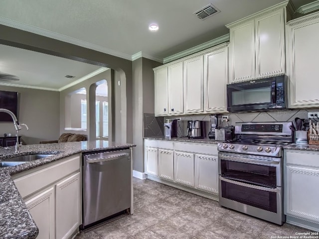 7566 Copper Cv, Converse, TX 78109 - kitchen with appliances with stainless steel finishes, crown molding, backsplash, dark stone counters, and white cabinets