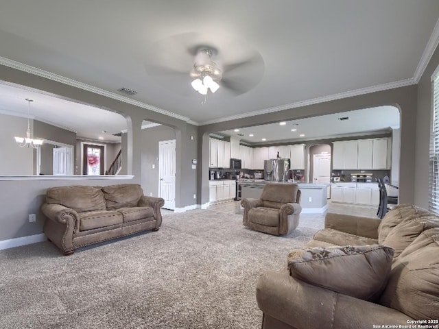 7566 Copper Cv, Converse, TX 78109 - living area with arched walkways, crown molding, a ceiling fan, a chandelier, and light carpet